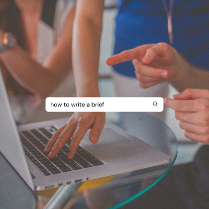 People using an Apple laptop and pointing at the screen. "How to write a brief" written in search bar overlaid.