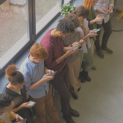 People standing holding smartphones and using social media.